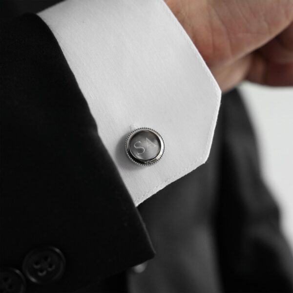 The groom wearing silver round beaded cufflinks for his wedding