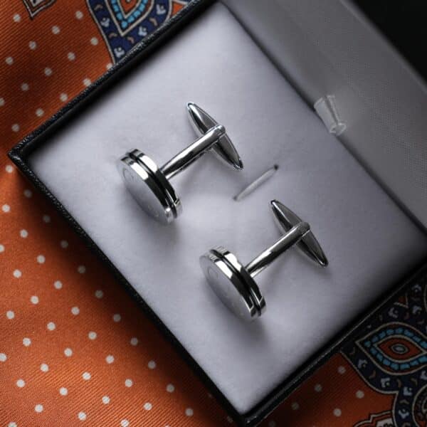 Overhead view of pin stripe cufflinks in gift box