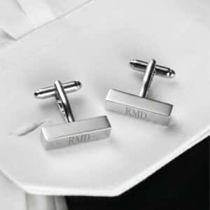 Silver rectangular cuff links worn with a white dress shirt