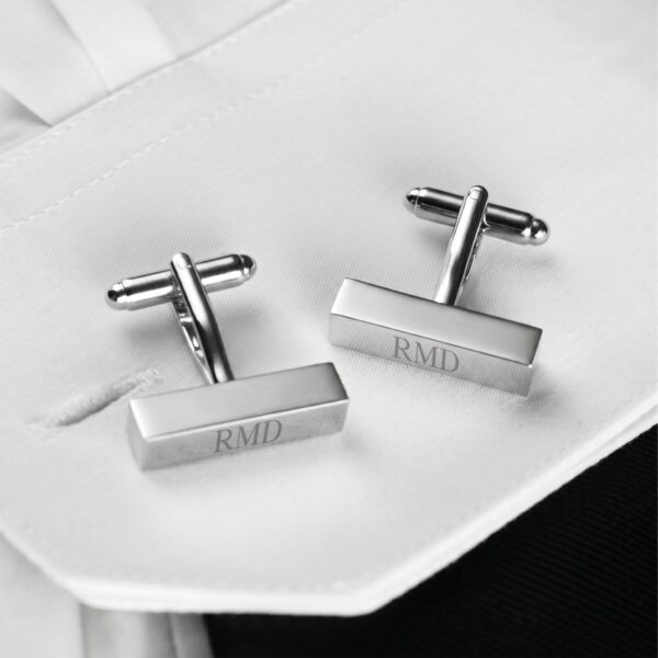 Silver rectangular cuff links worn with a white dress shirt