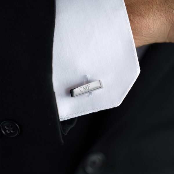 Groom wearing engraved cuff link bars for the wedding day