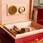 The groom and groomsmen smoking cigars before the wedding.
