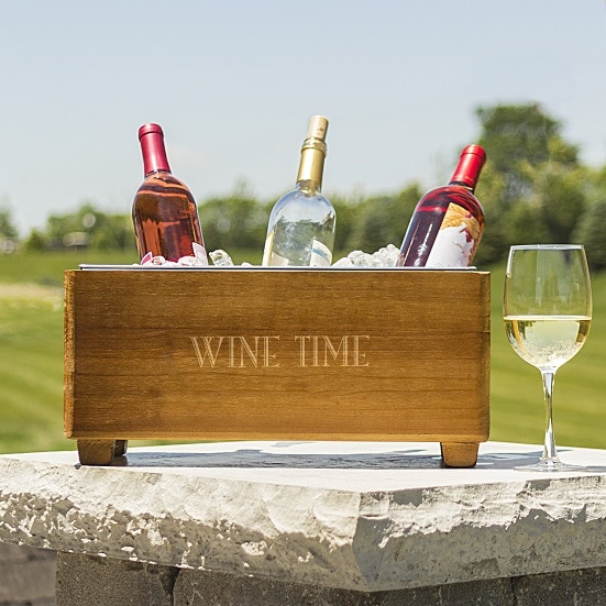 Engraved beverage trough full of wine on a summer picnic afternoon