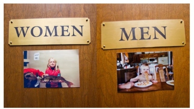 bathroom door photos of bride and groom as children