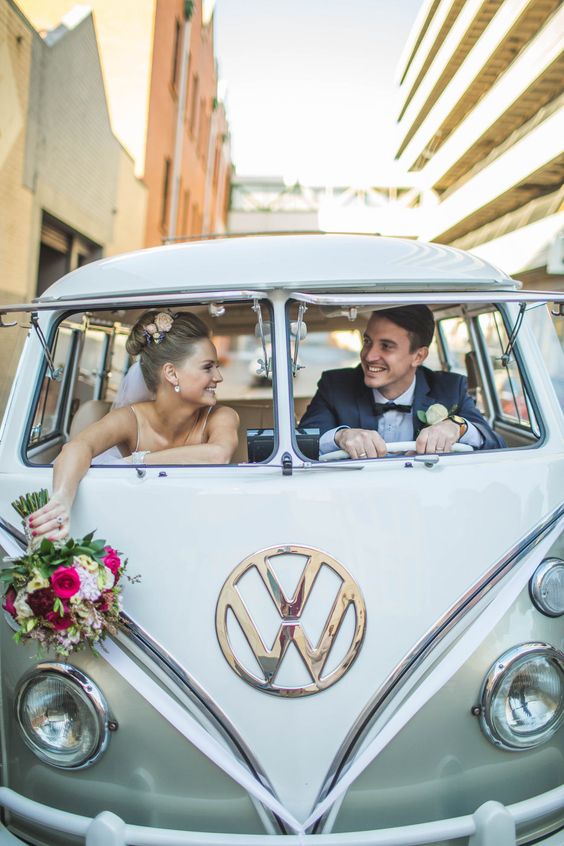 bride and groom in vw bug getaway car