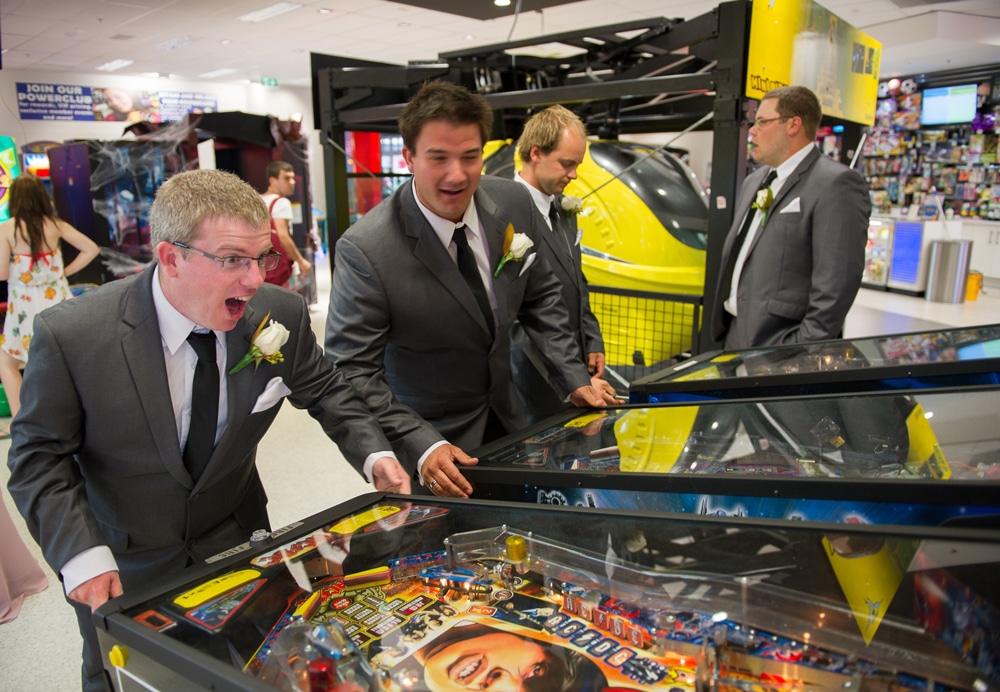 groomsmen playing arcade games