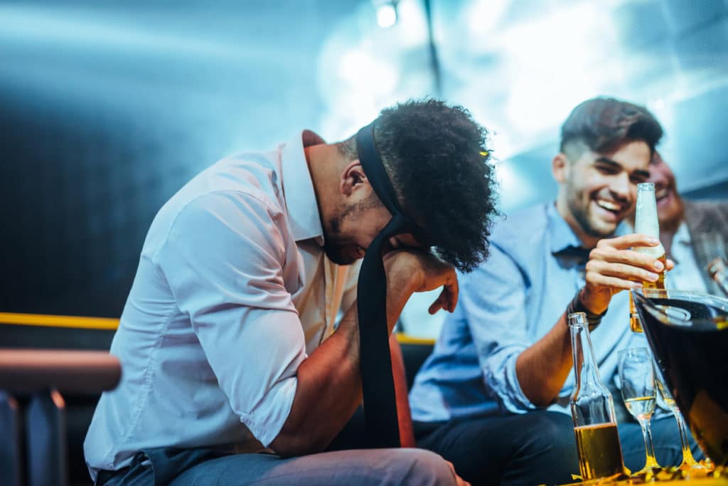 bachelor laughing in the nightclub at his bachelor party