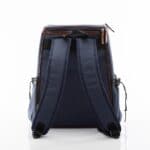 Reverse side of the blue backpack cooler that shows the arm straps.