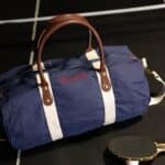 Blue Canvas & Leather Duffle Bag on a Ping Pong Table