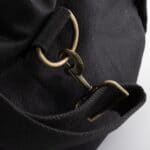 Hardware close-up on the black canvas & leather duffle bag