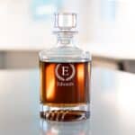 Engraved round decanter with laurel wreath monogram