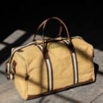 Personalized canvas duffle bag with red plaid interior and vegan leather accents