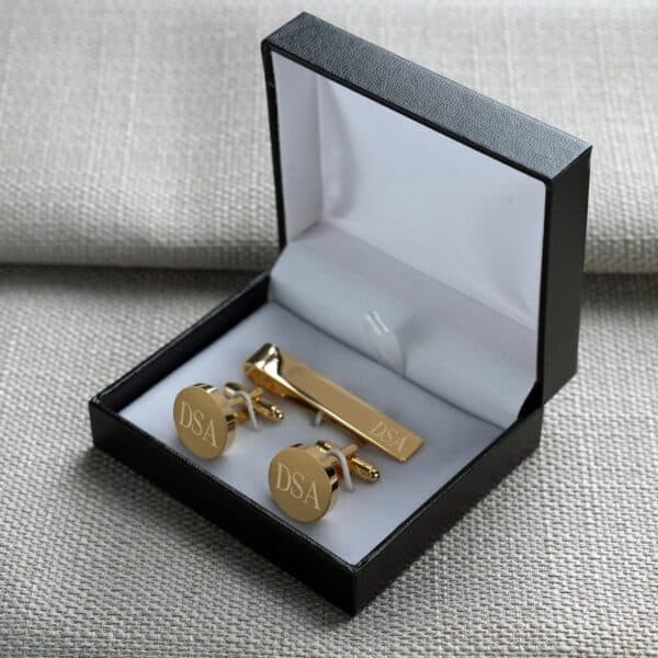 Each gold cufflink and tie bar set arrives in a padded black gift box