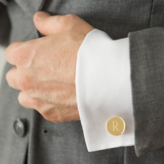Groom wearing gold cufflinks for wedding