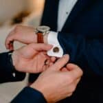 Groomsman wearing gold round cufflinks