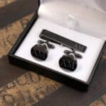 Close-up of the gift boxed tie bar and cufflink set in gunmetal
