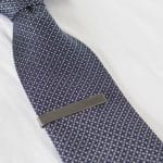 The gunmetal tie bar easily attaches to any size tie.