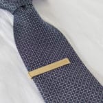 Engrave a name, set of initials or "groomsmen" on the front of the gold tie clip.