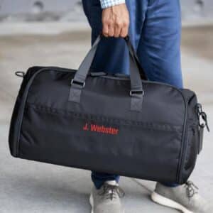 The Suit Saver v2 Bag shown in black with custom red embroidery on the front