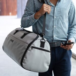 Grey Suit Saver v2 being worn over shoulder and used as a duffle bag