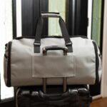 The Suit Saver v2 Bag shown in grey with the trolley sleeve in use.