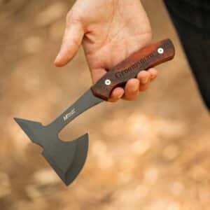 Gripping the mini hatchet by the engraved handle