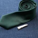 Silver tie tack paired with a green tie
