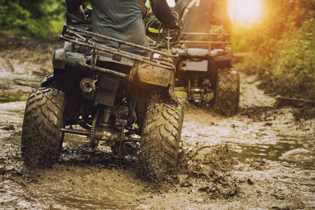 man riding atv vehicle on off road track