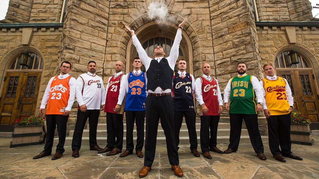 groomsmen all wearing lebron james jerseys as the groom imitates lebron's pre-game ritual