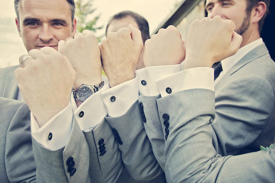 groomsmen posing with their new personalized cufflinks