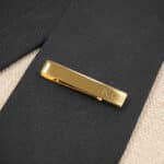 The gold tie bar with black tie is a timeless wedding look for the groomsmen