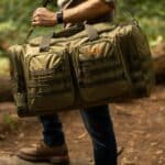 A man carrying the XL Tactical Duffle Bag over his shoulder