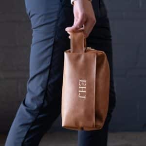 The brown leather dopp kit is easy to carry and will easily fit in your suitcase or luggage.