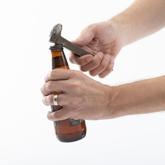 Using a railroad spike to open a beer bottle