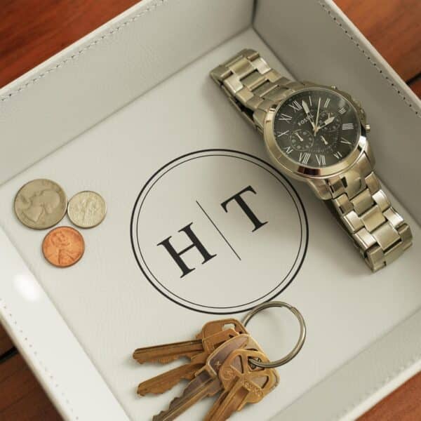 White stash tray with engraved circle monogram design