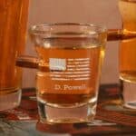 Shot glass engraved with the American Flag and featuring a real real, lead-free .308 bullet stuck in the side