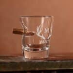 Empty shot glass with bullet