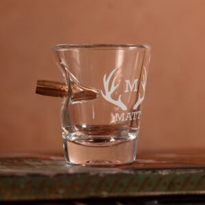 Empty shot glass with bullet