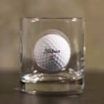The custom rocks glass features a real Titleist golf ball "stuck" in the side.