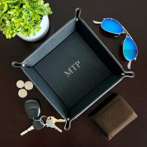 Men's black valet stash tray on dresser