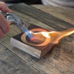 Using a mini torch to make homemade smokey cocktails