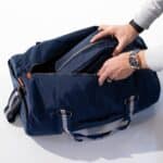 Blue personalized nylon toiletry bag fits comfortably inside the larger deluxe duffle bag