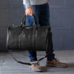 A man holding his black Maverick duffle bag by the handles