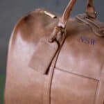 Brown vegan leather duffle bag - luggage tag