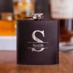 Black matte "Zero Dark Thirsty" flask shown with split monogram design