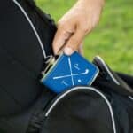 A golfer pulling a flask out of his golf bag