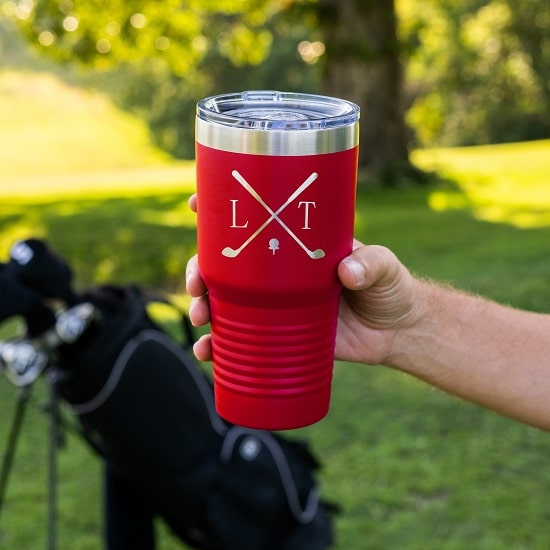 Red golf tumbler in golfer's hand