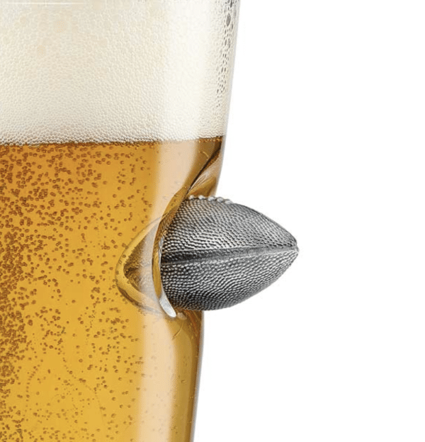 Close-up of the embedded mini metal football that's "stuck" in the side of the pint glass
