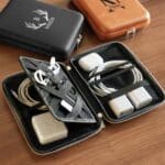 Travel cord case shown full of cords and tech items