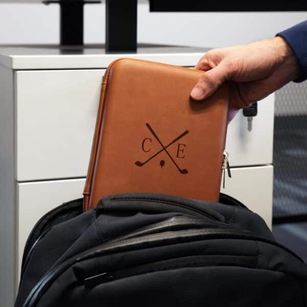 Rawhide cord case being pulled from a backpack